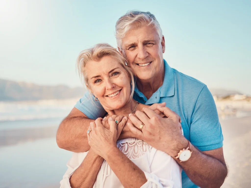 Senior couple smiling with dental implants