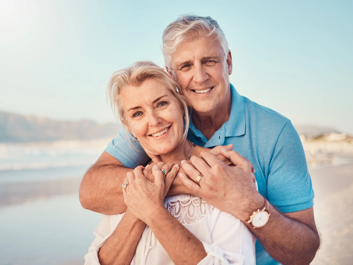 Senior couple smiling with dental implants in Wilmington, NC.
