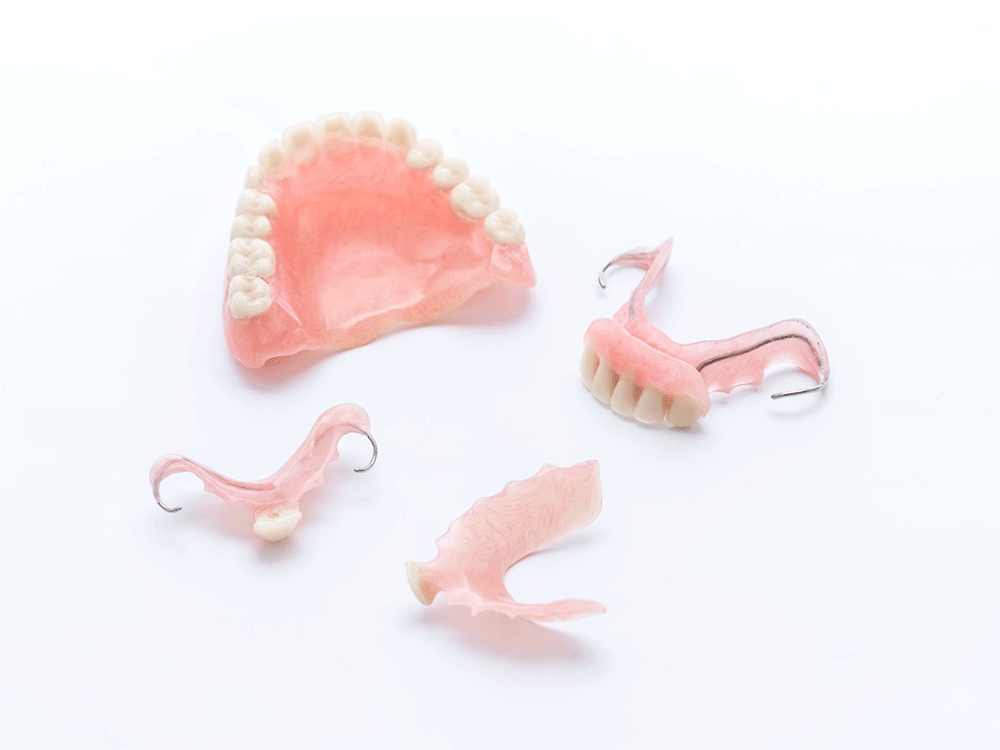 Photo of different types of dentures including, full dentures and partial dentures.