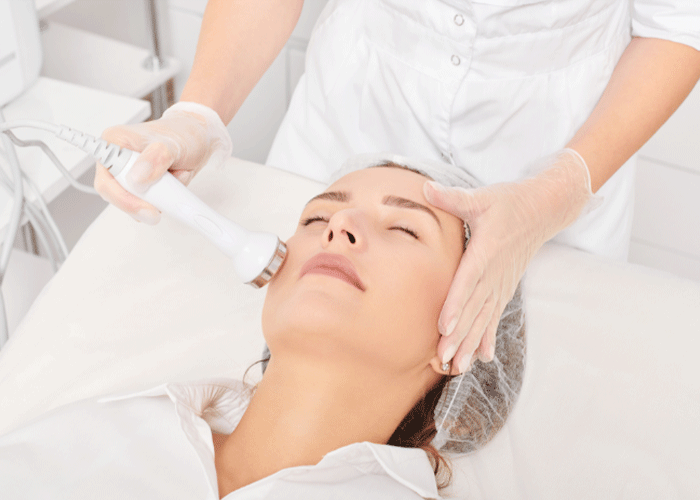 Woman receiving skin rejuvenation treatment on her face.